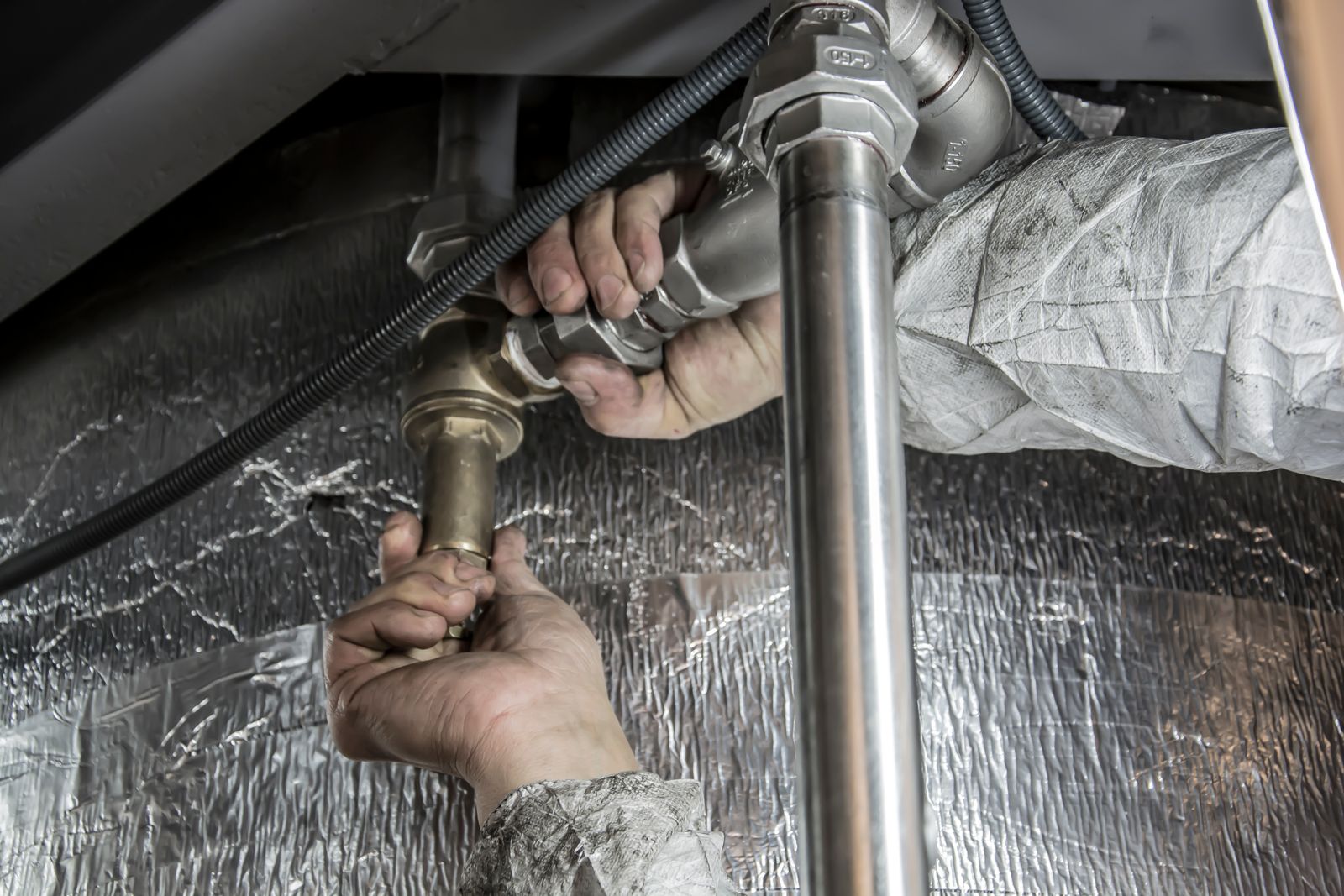 Plumber working on pipework in a Dubai home